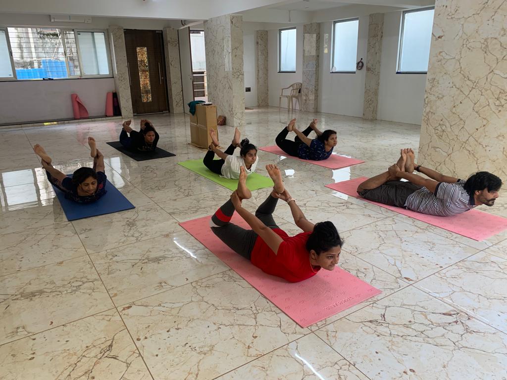 Yoga instructor guiding students in Pune